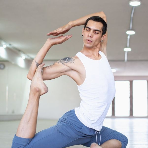 Man performing a controlled strength exercise in a minimalist setting.